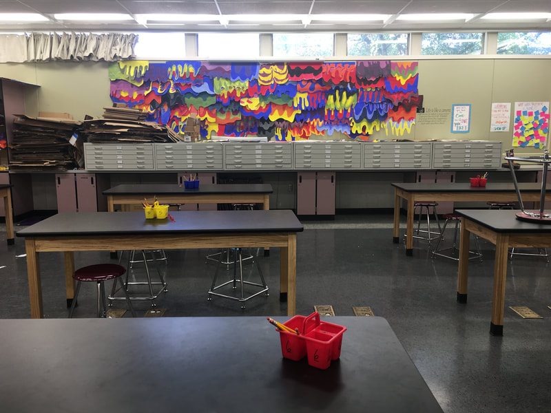 New art classroom for 36 students at Central Middle School: tables, stools, flat files, drying rack, supplies.